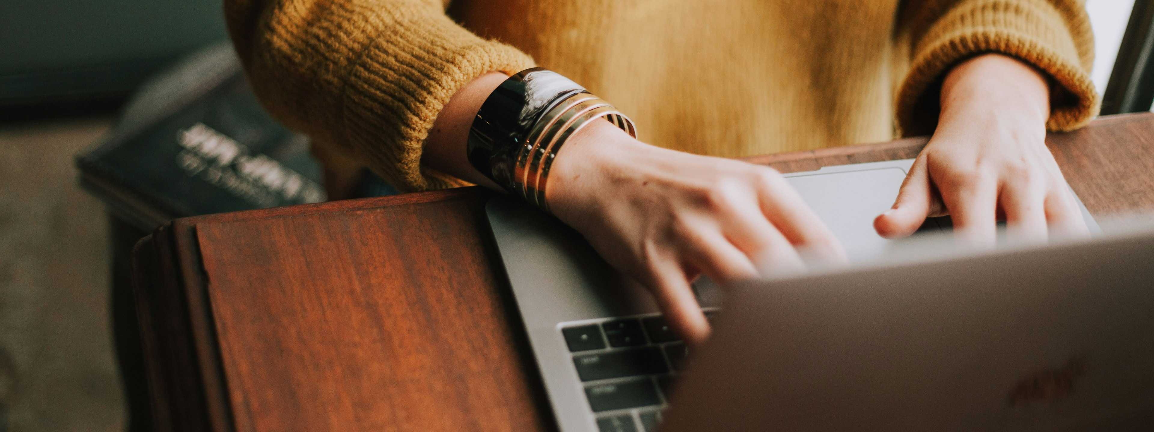 Close up image of a woman using a laptop