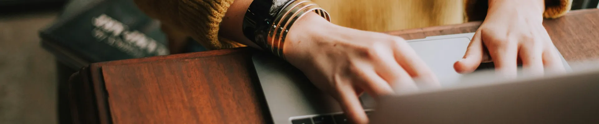 Close up image of a woman using a laptop