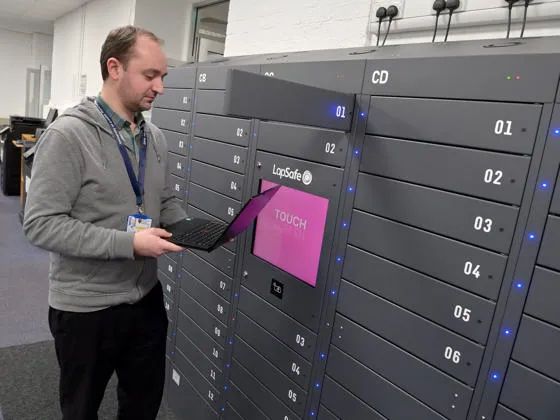 Person borrowing a laptop from self-service laptop loan cabinets