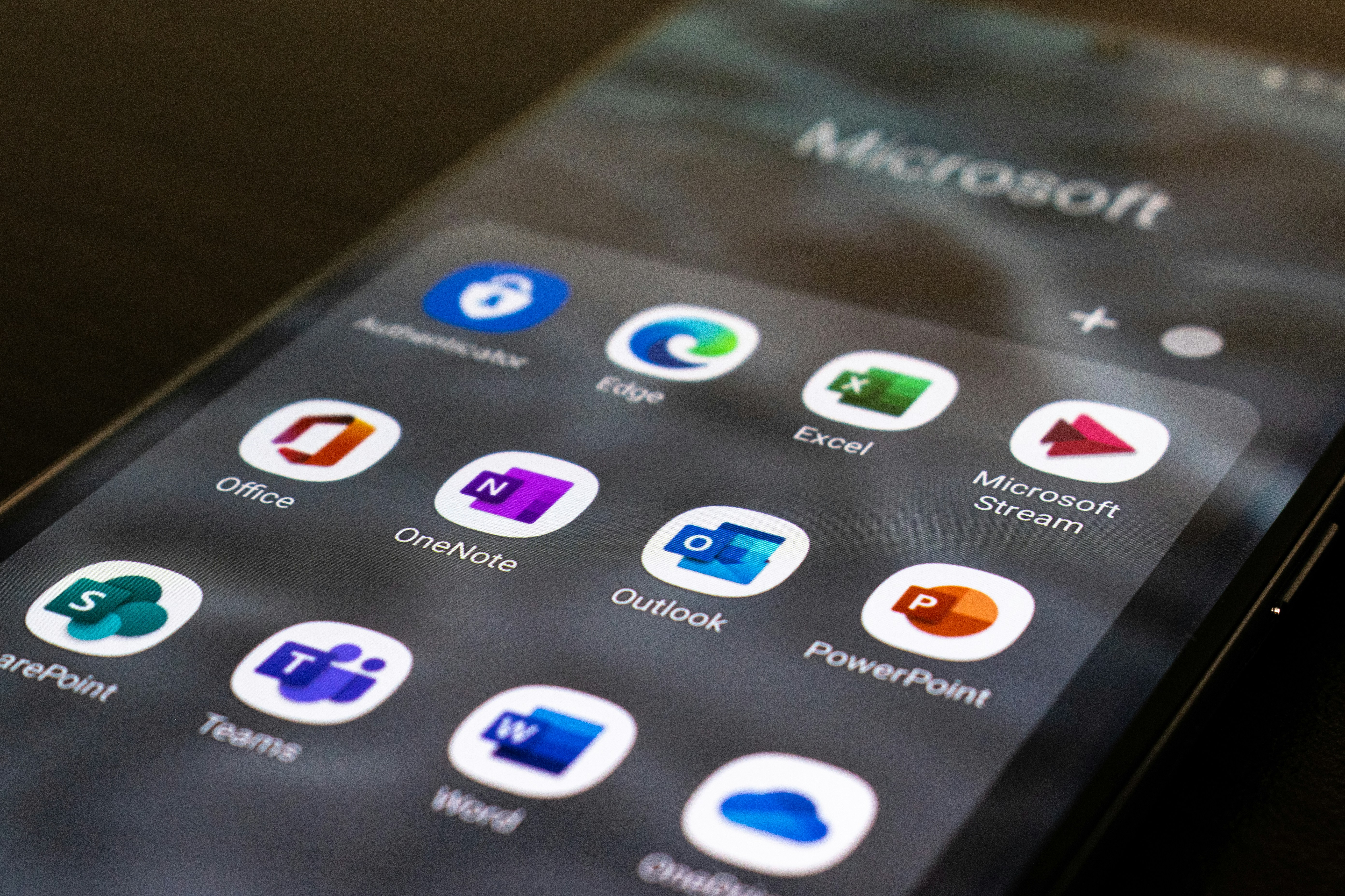 Smartphone screen displaying a grid of Microsoft 365 apps.