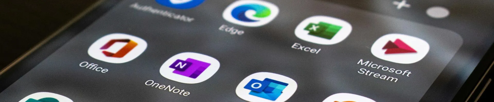 Smartphone screen displaying a grid of Microsoft 365 apps.