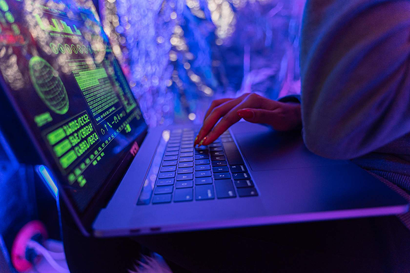 A futuristic hacker using a laptop