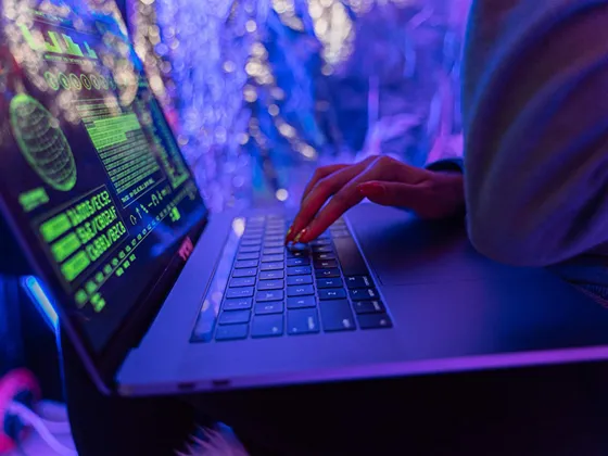 A futuristic hacker using a laptop